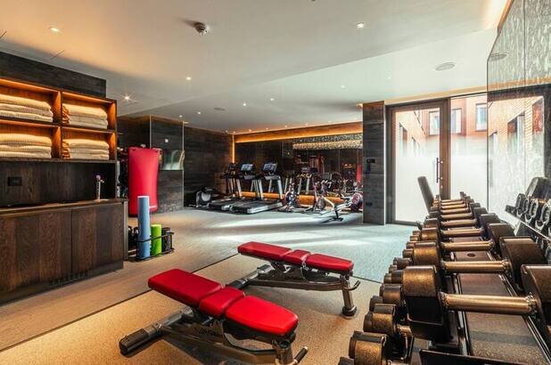 The gym at The Fellows House in Cambridge, with exercise bikes, treadmills, benches and free weights
